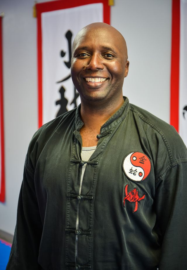 Sifu Moses smiling in his training uniform